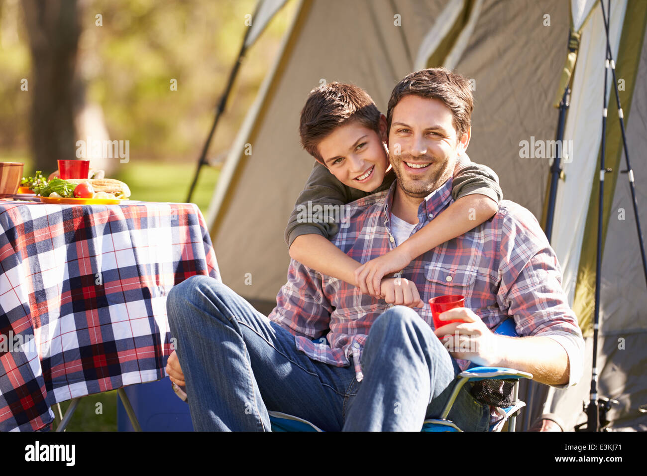 Father And Son Enjoying Camping Holiday In Countryside Stock Photo