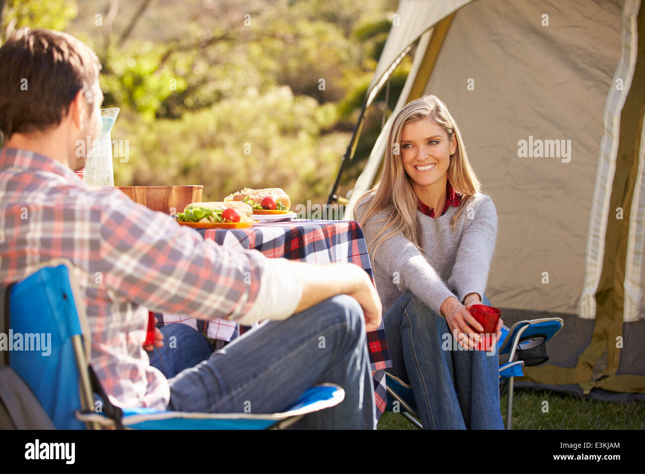 Couple Enjoying Camping Holiday In Countryside Stock Photo