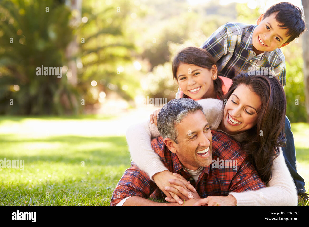 Family Lying On Grass In Countryside Stock Photo