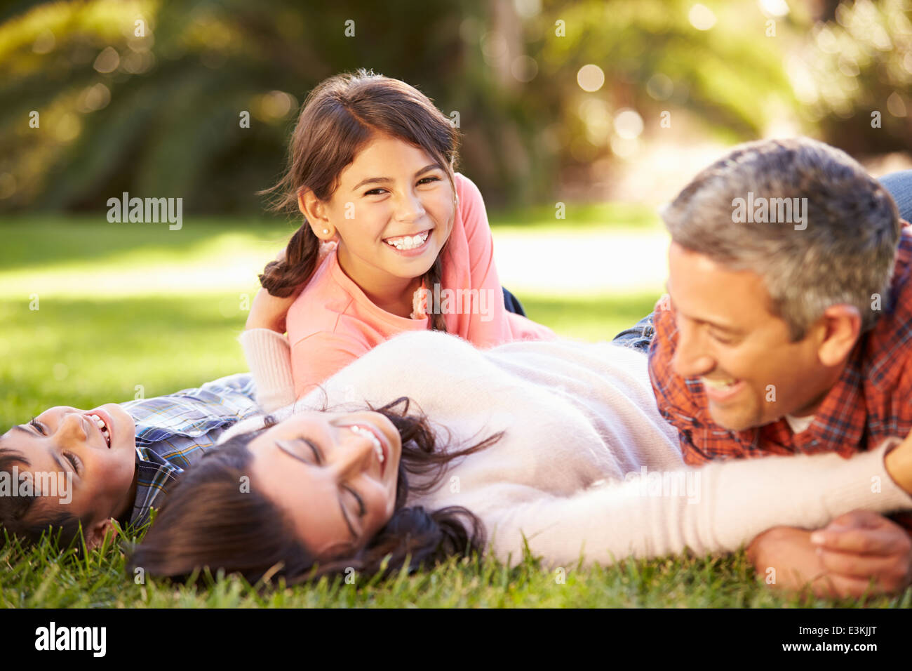 Family Lying On Grass In Countryside Stock Photo