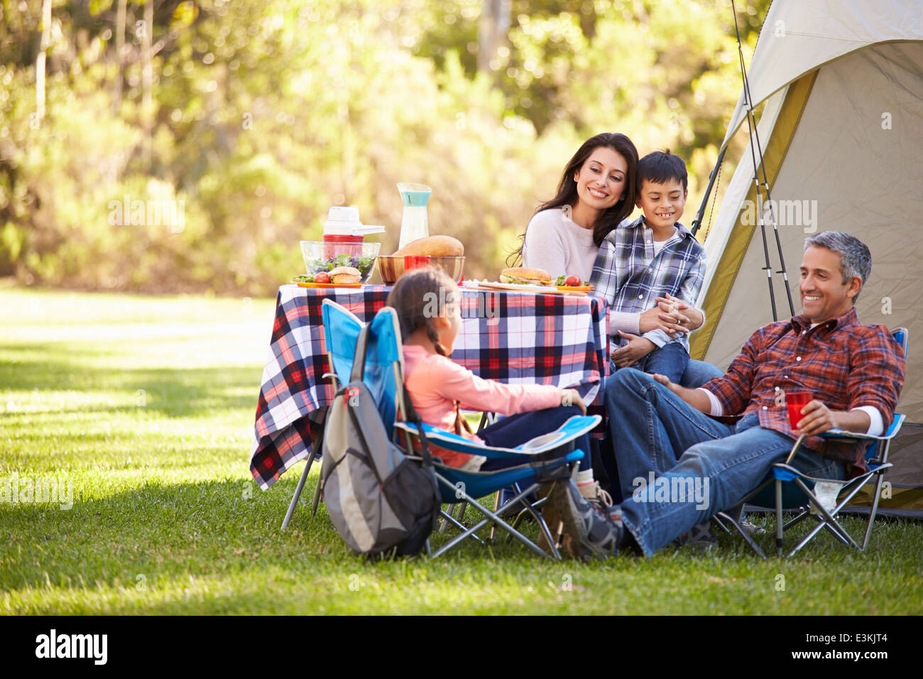 Family Enjoying Camping Holiday In Countryside Stock Photo