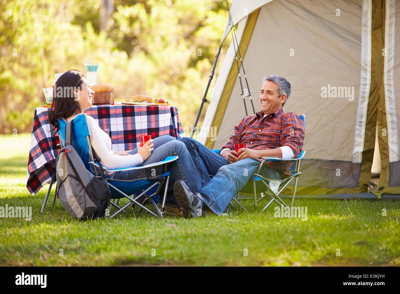 Couple Enjoying Camping Holiday In Countryside Stock Photo
