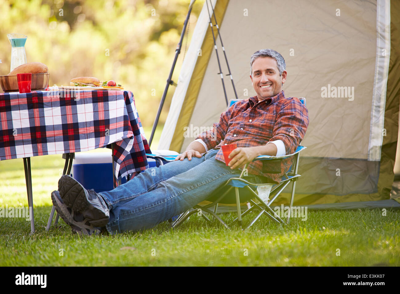 Man Enjoying Camping Holiday In Countryside Stock Photo Alamy