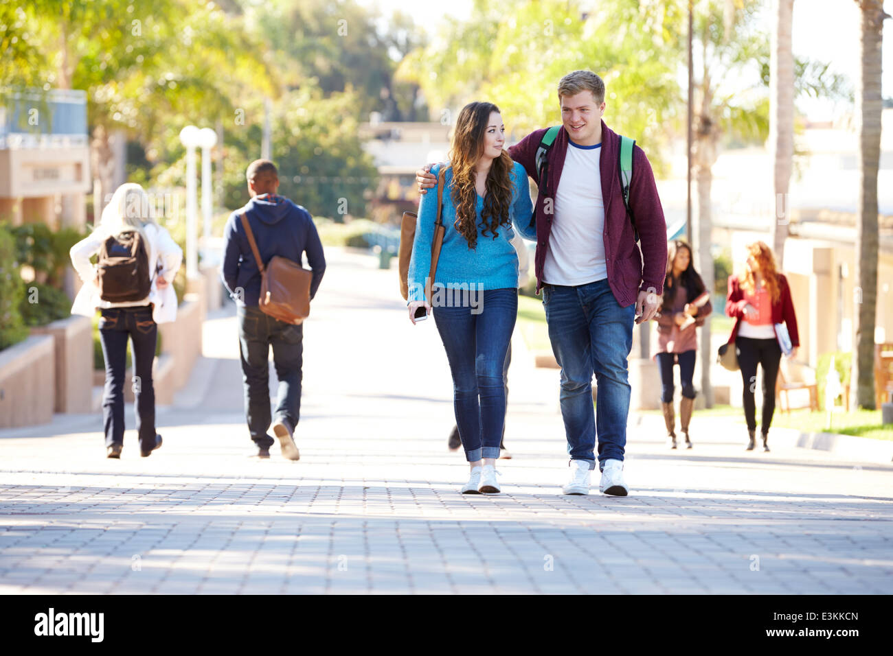 Student Couple Walking Outdoors On University Campus Stock Photo - Alamy
