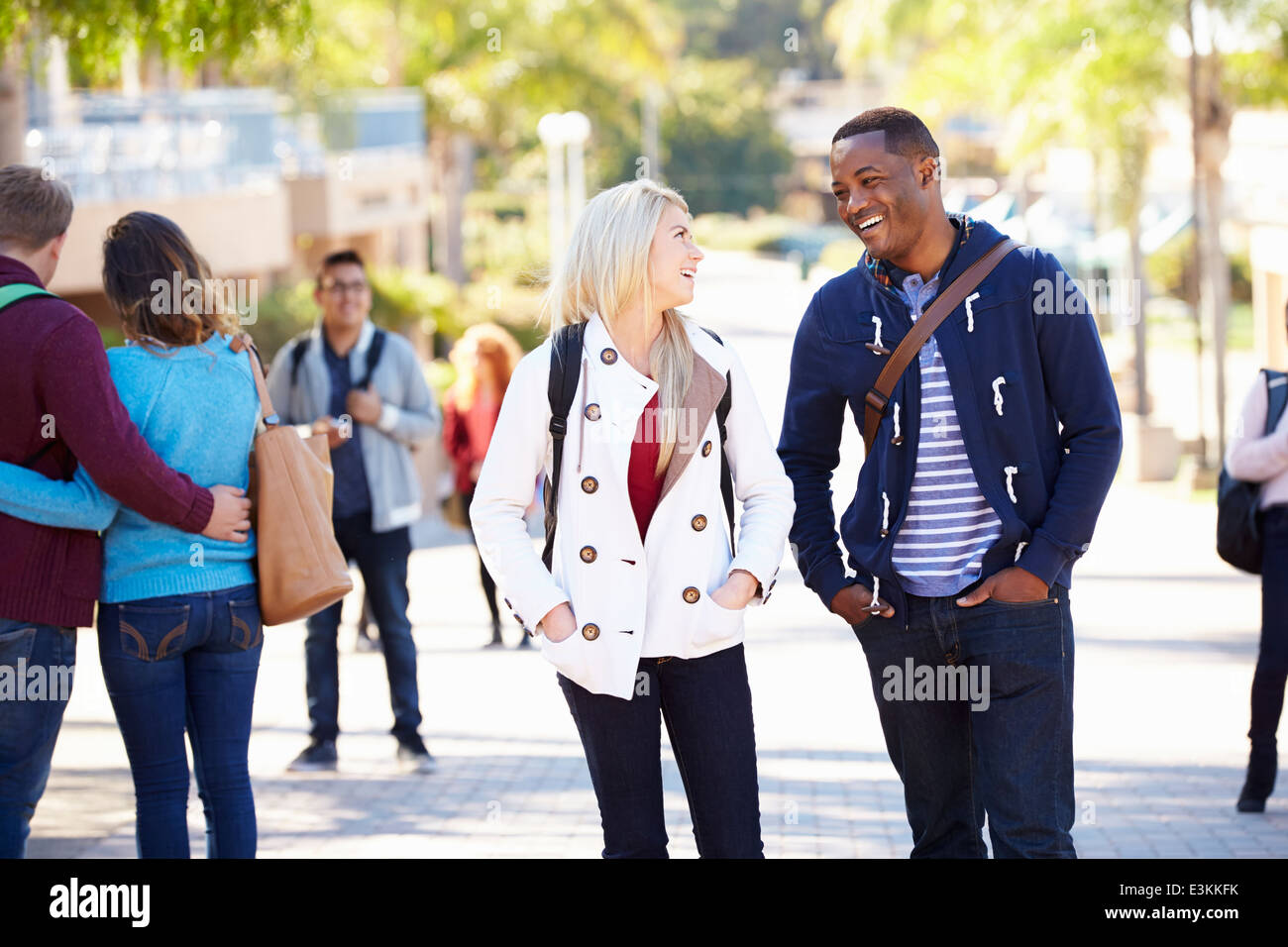 Students Walking Outdoors On University Campus Stock Photo