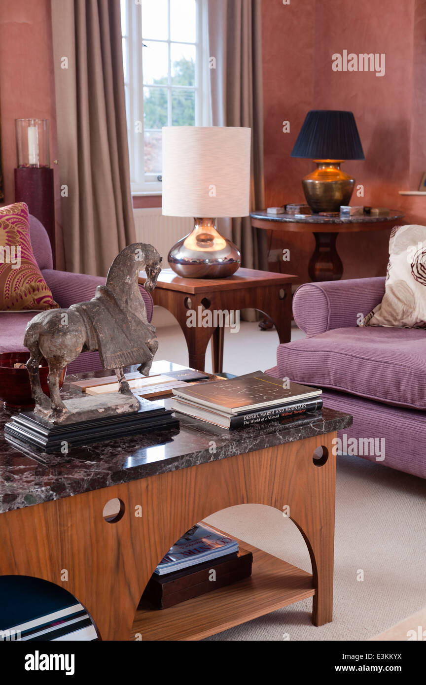 Horse statue on marble topped table designed by Beckford. The sofas are upholstered in Maya by Manuel Canovas Stock Photo
