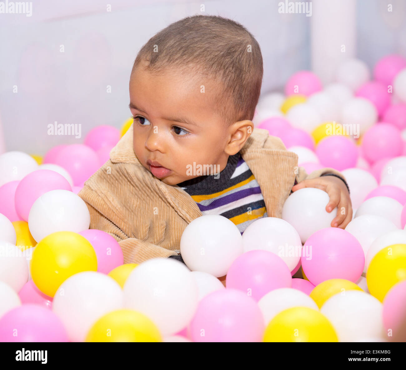 Happy black boy in colored ball on birthday on playground. The concept of childhood and holiday Stock Photo