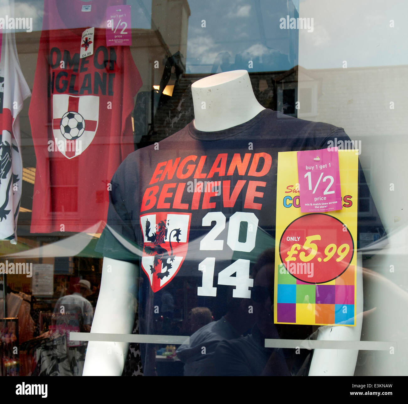 Christchurch, Dorset, UK. 23rd June 2014. An 'England Believe' 2014 supporters shirt for sale at a reduced price in a high street shop window in Christchurch, Dorset, UK on the eve of England's last game in the World Cup in Brazil after getting knocked out of the competition at the group stage for the first time in 56 years. Credit:  Rob Wilkinson/Alamy Live News Stock Photo