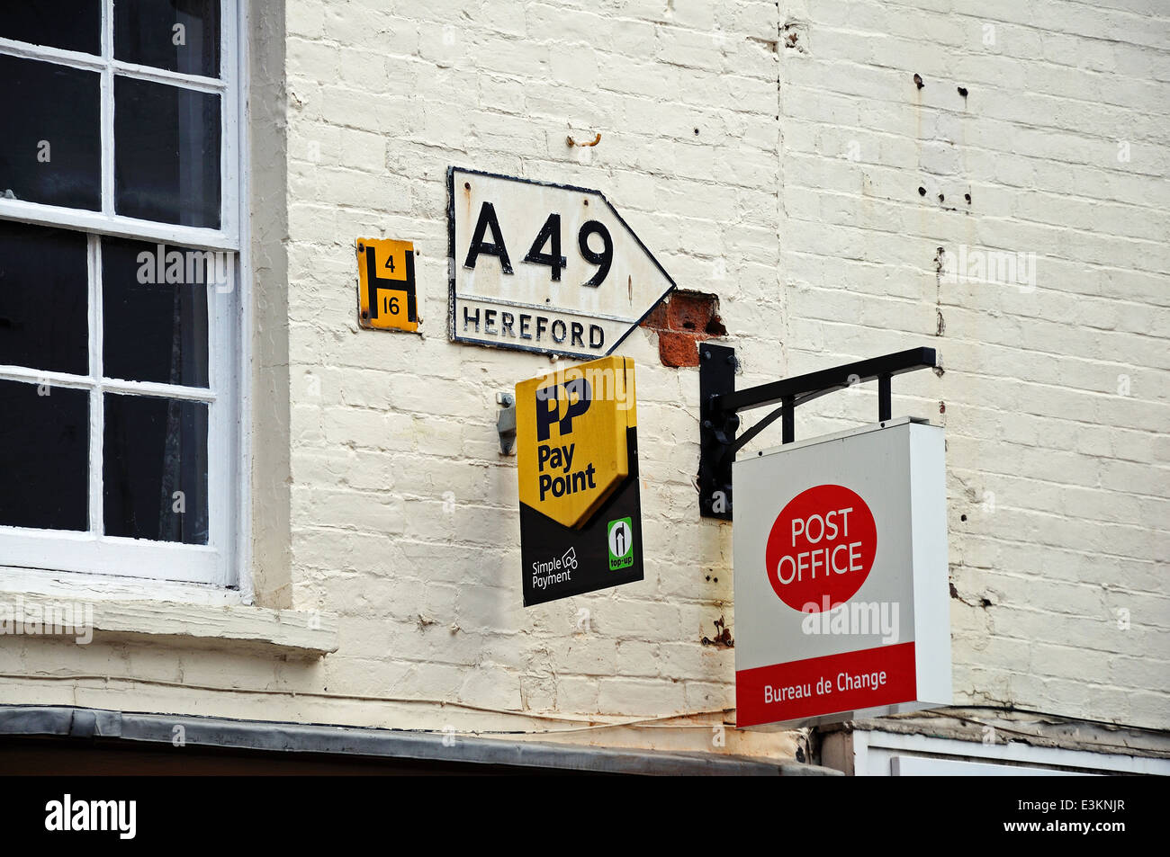 Four signs on a building wall, Leominster, Herefordshire, England, UK, Western Europe. Stock Photo