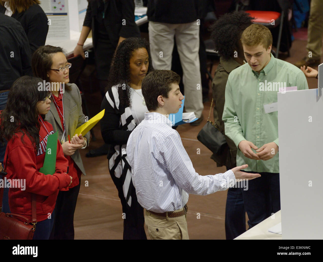 Students explaining posters of their science research projects to judges at a science symposium/ science fair, New Jersey Stock Photo