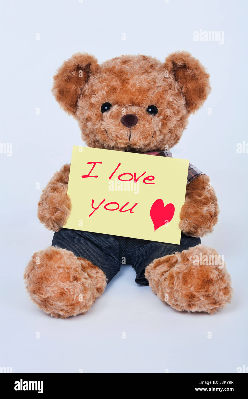 A Cute Teddy Bear Holding A Yellow Sign That Says I Love You On A Stock Photo Alamy