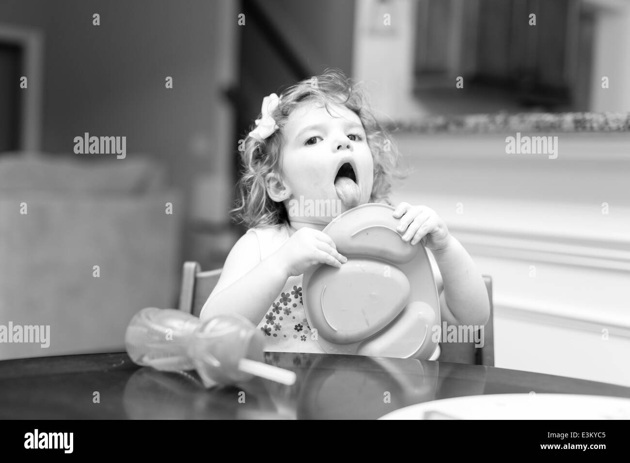 Little girl at dinner time making facial expressions Stock Photo