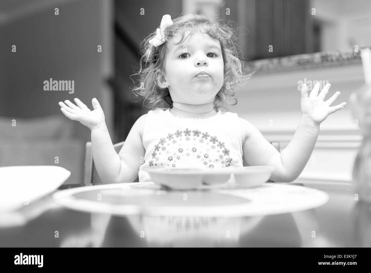 Little girl at dinner time making facial expressions Stock Photo