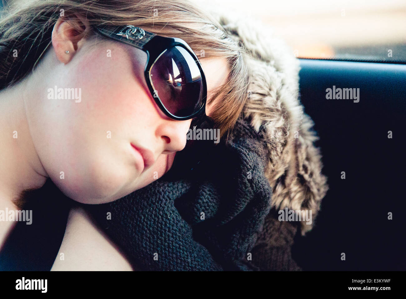 Picture of teenage girl (13-15) sleeping in car Stock Photo