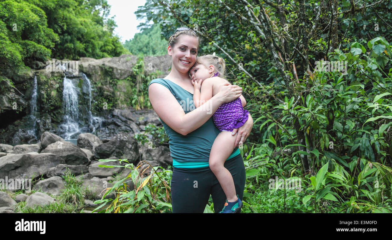 Mother and child by Maui waterfall Stock Photo