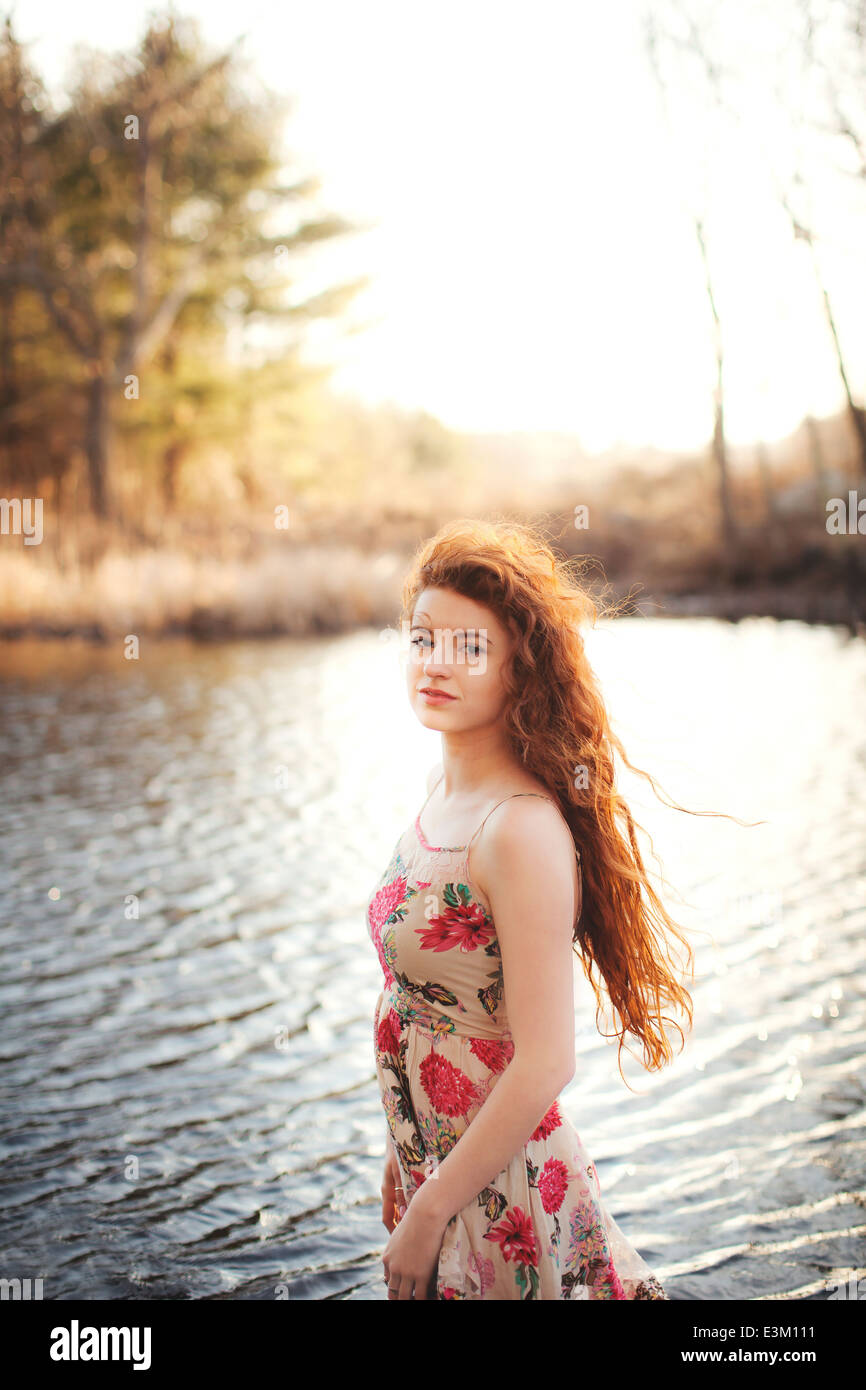 Young woman (18-19) standing in shallow water Stock Photo