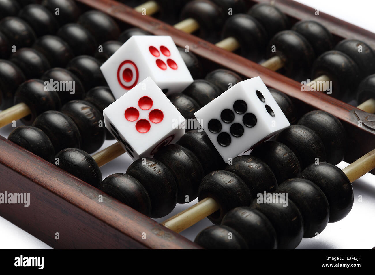 three dice on abacus are symbolic of gambling Stock Photo