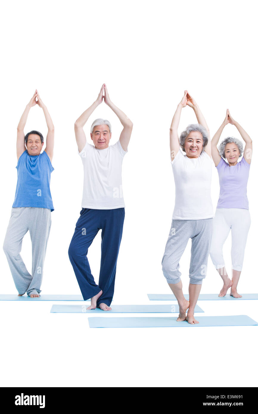 Senior adults practicing yoga Stock Photo