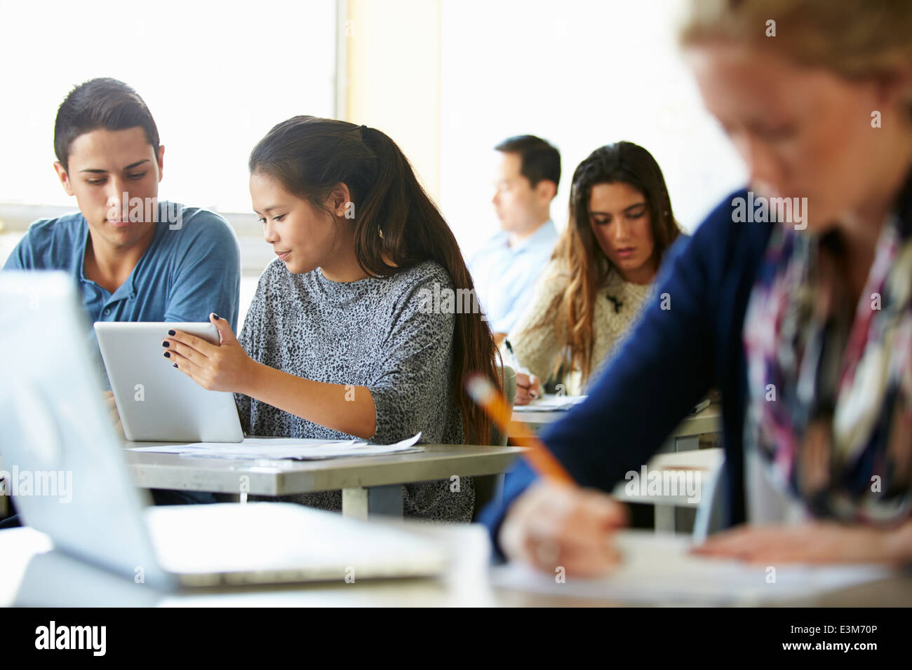 High School Students With Laptops And Digital Tablets Stock Photo
