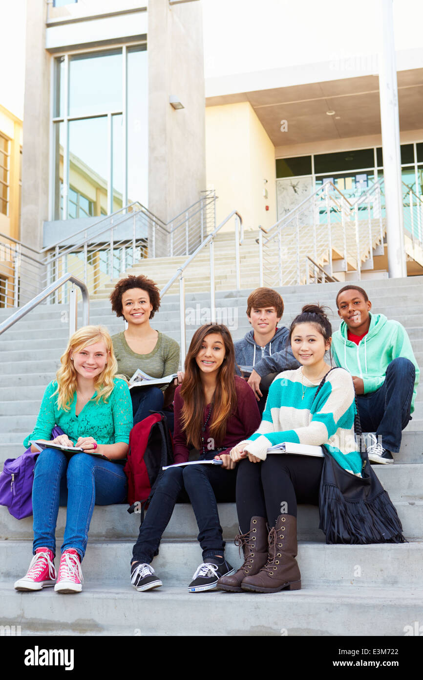 Portrait Of High School Students Sitting Outside Building Stock Photo