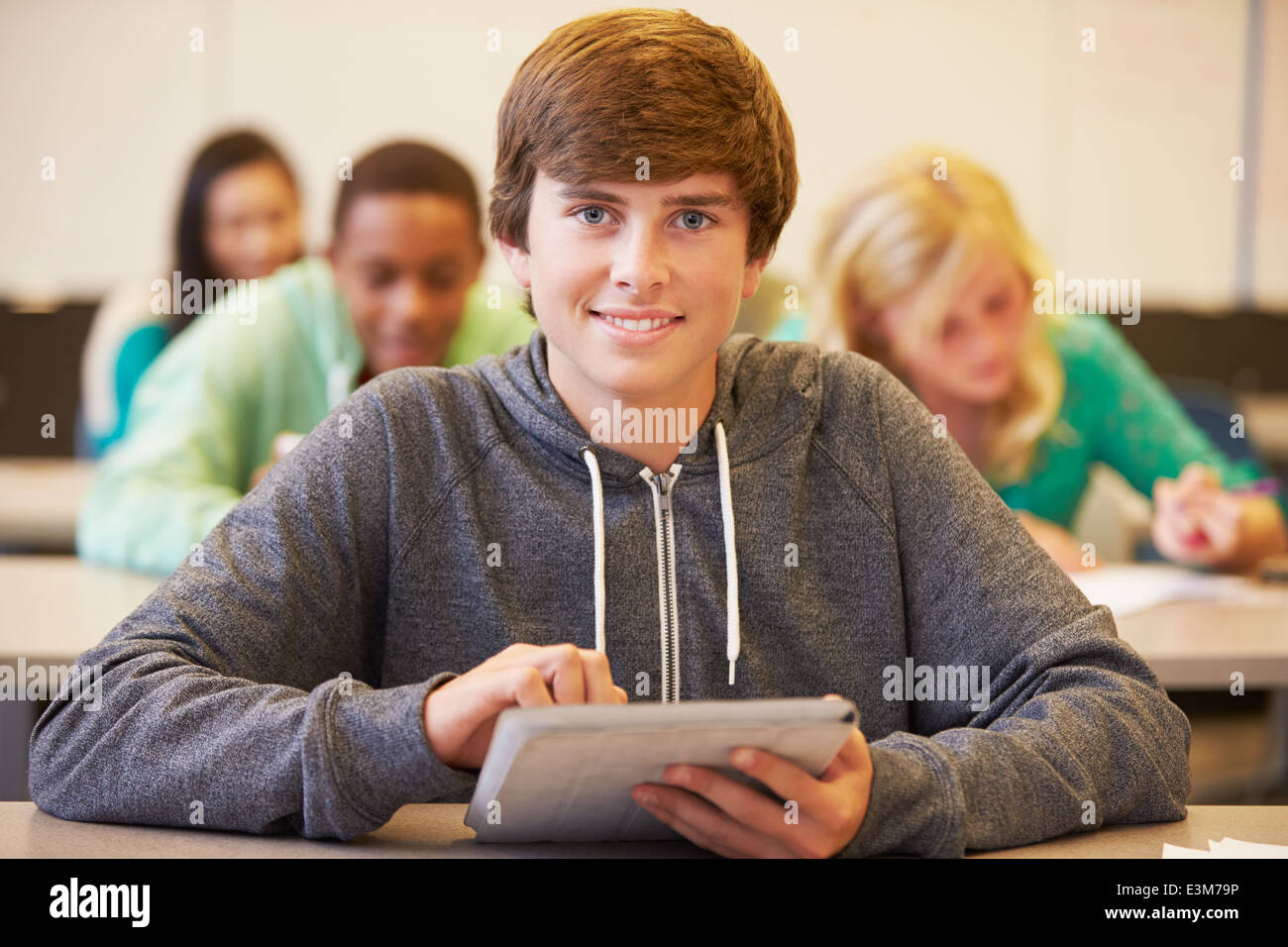 Male High School Student Studying At Desk In Classroom Stock Photo - Alamy