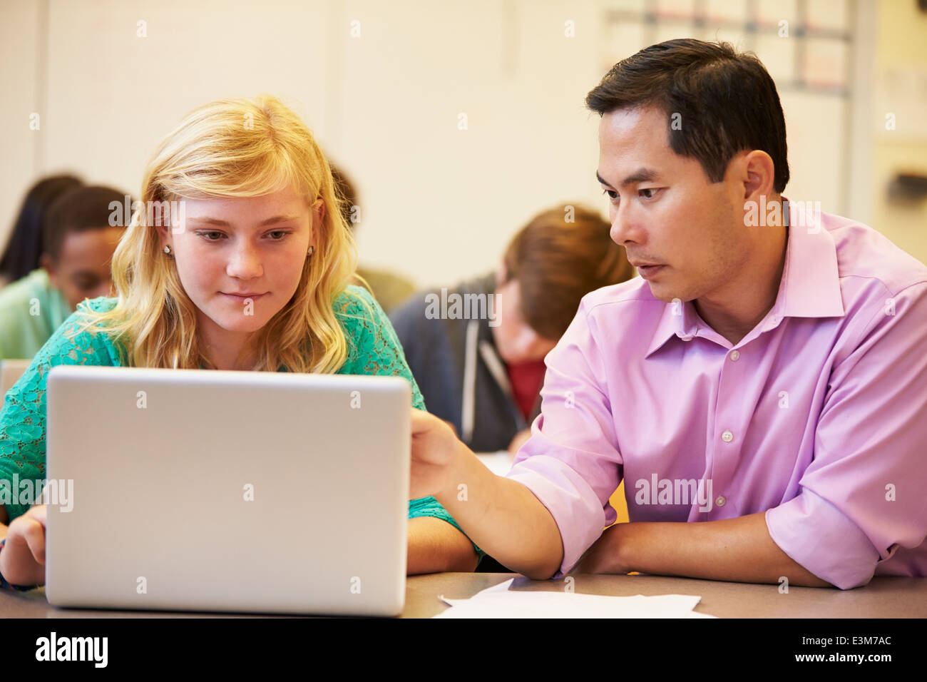 High School Student With Teacher In Class Using Laptop Stock Photo - Alamy