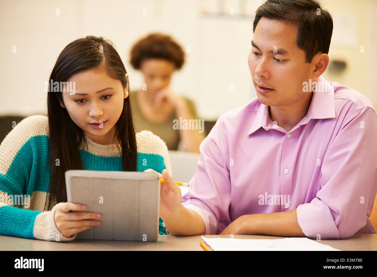 High School Student And Teacher Using Digital Tablet Stock Photo