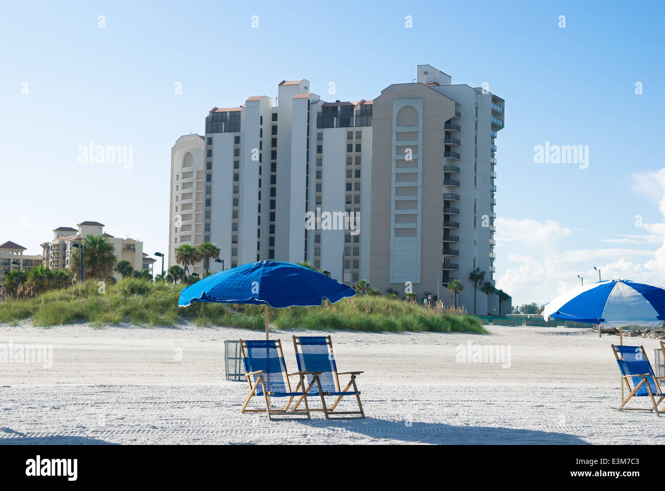 beach with deck chair near to buildings in a sunny morning Stock Photo