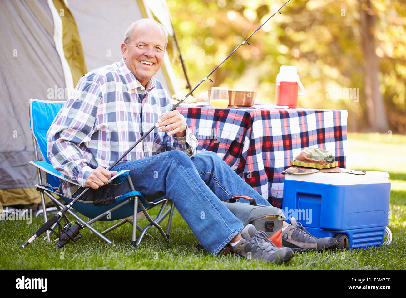 Senior Man On Camping Holiday With Fishing Rod Stock Photo