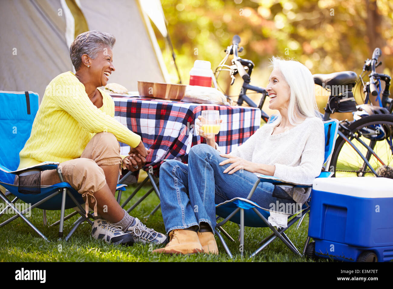Two Mature Women Relaxing On Camping Holiday Stock Photo