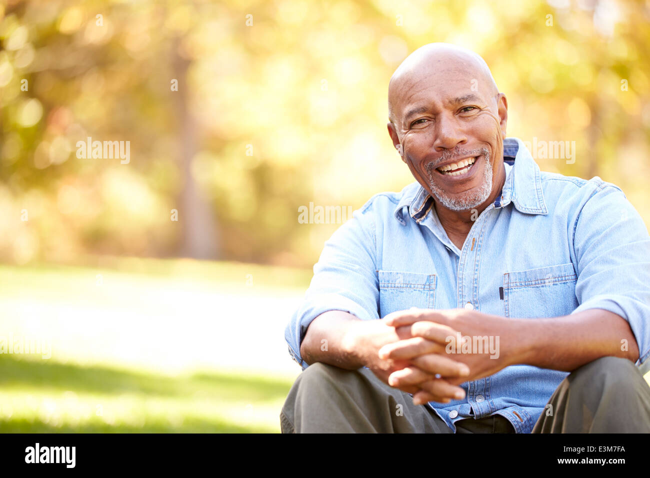 Senior Man Relaxing In Autumn Landscape Stock Photo