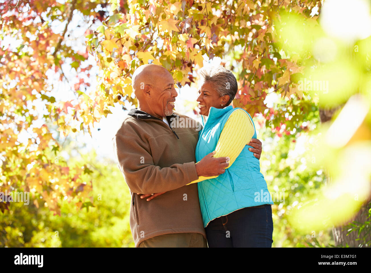 Senior Couple Walking Through Autumn Woodland Stock Photo - Alamy