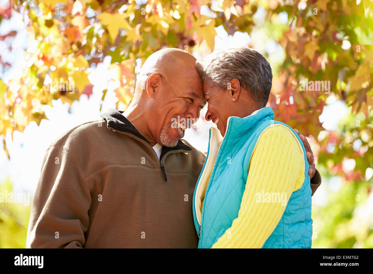 Senior Couple Walking Through Autumn Woodland Stock Photo - Alamy