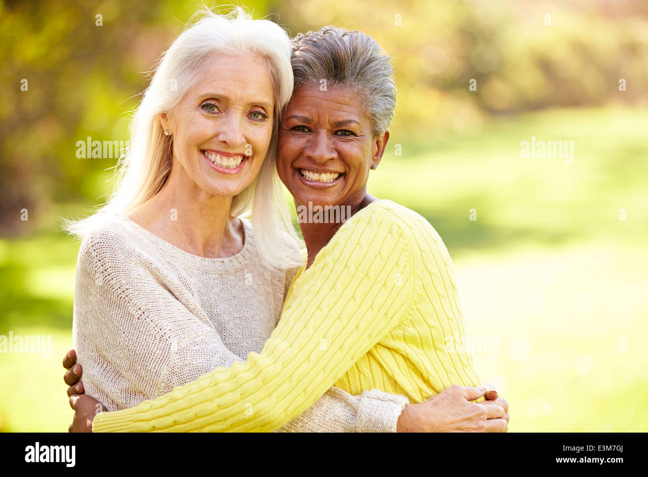 Portrait Of Two Mature Female Friends Hugging Stock Photo