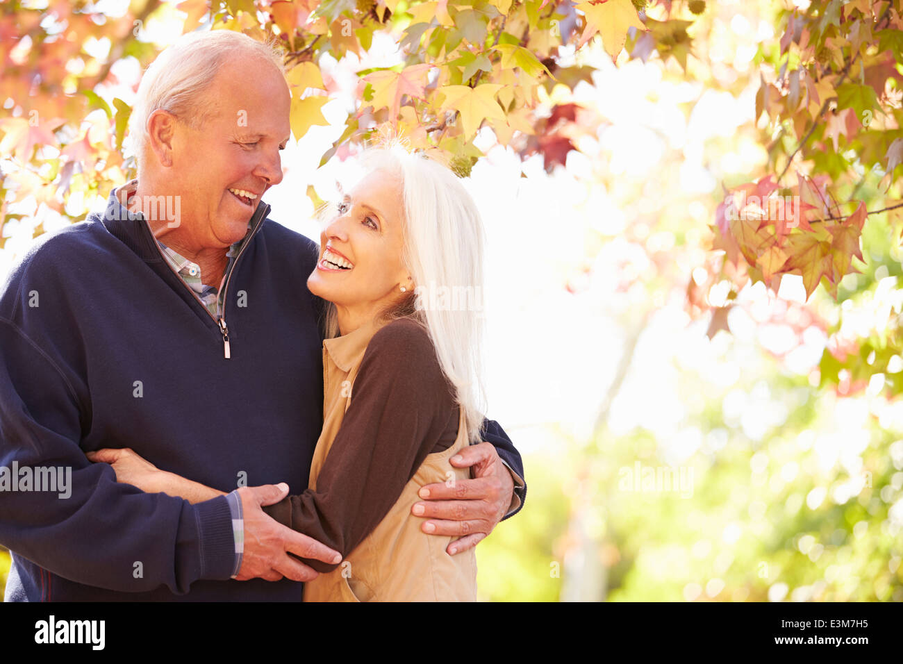 Senior Couple Walking Through Autumn Woodland Stock Photo - Alamy
