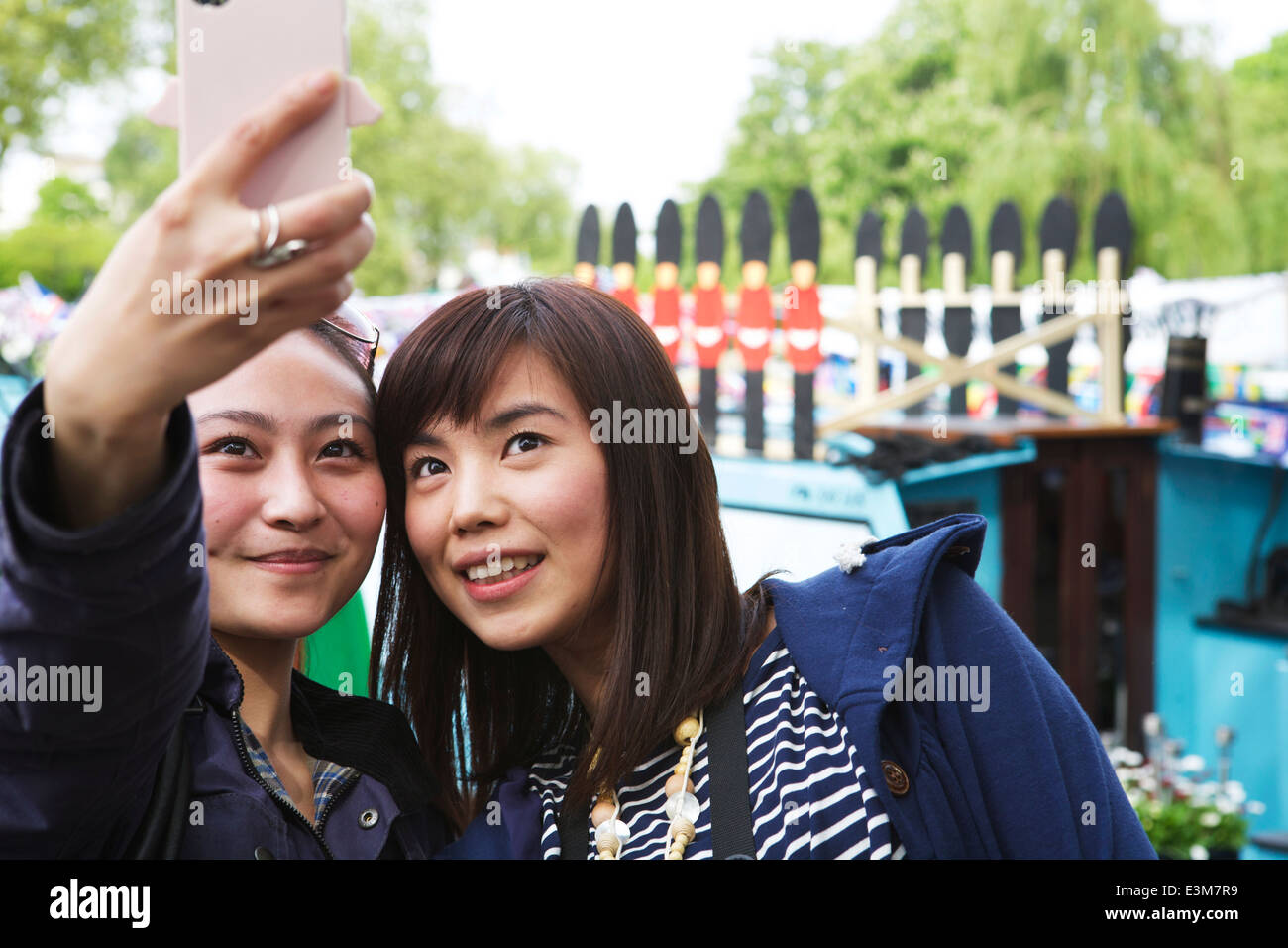 Two Asian tourists taking a selfie at Little Venice, London UK. Tourists London. Stock Photo