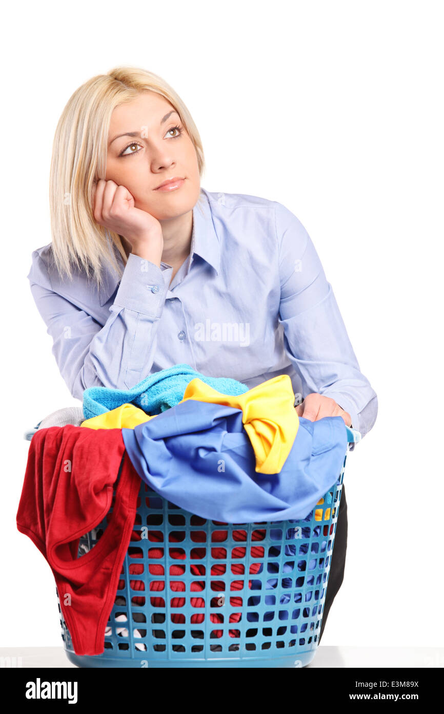 Bored woman leaning on a laundry basket Stock Photo