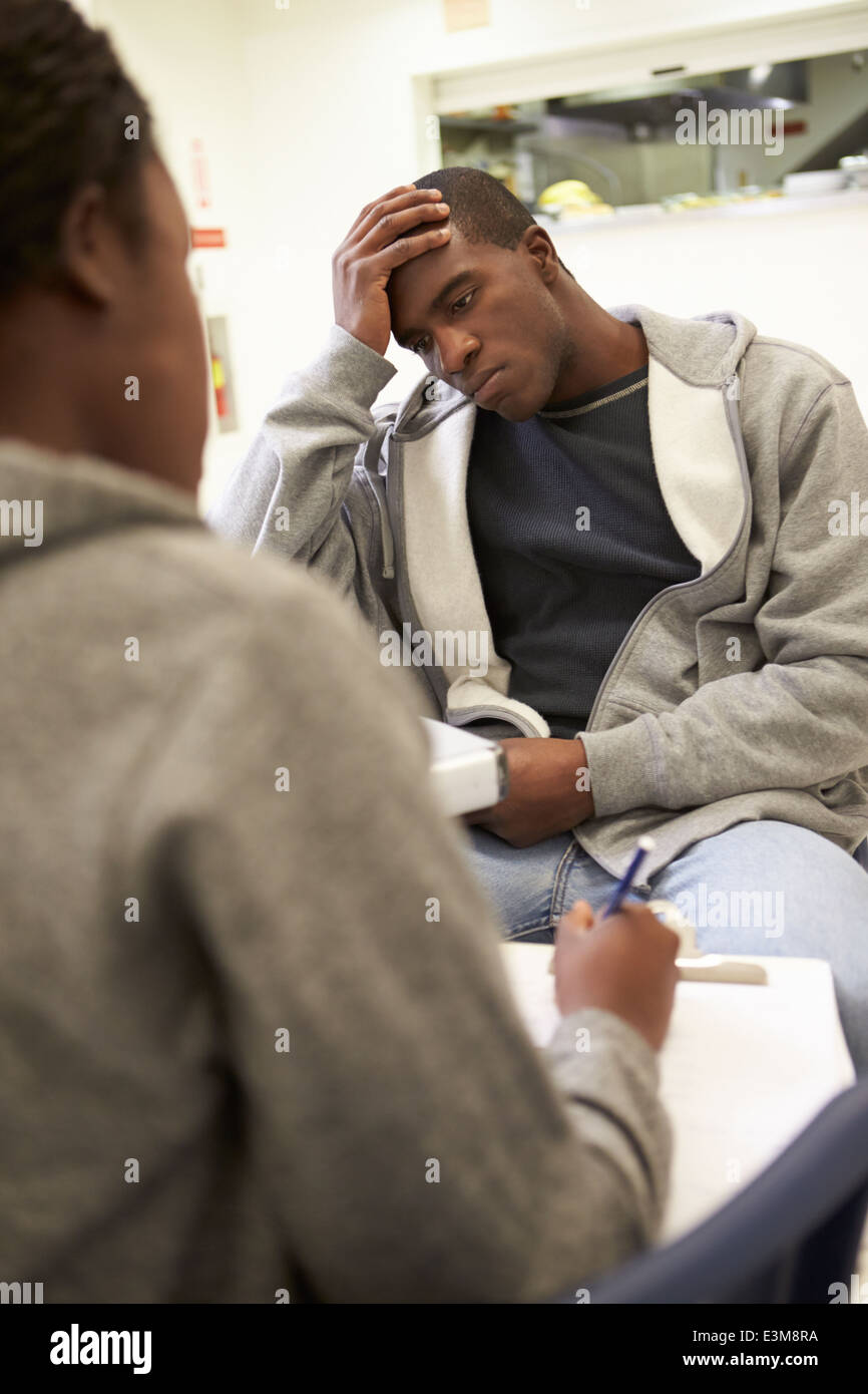 Man Talking To Counsellor Who Takes Notes Stock Photo