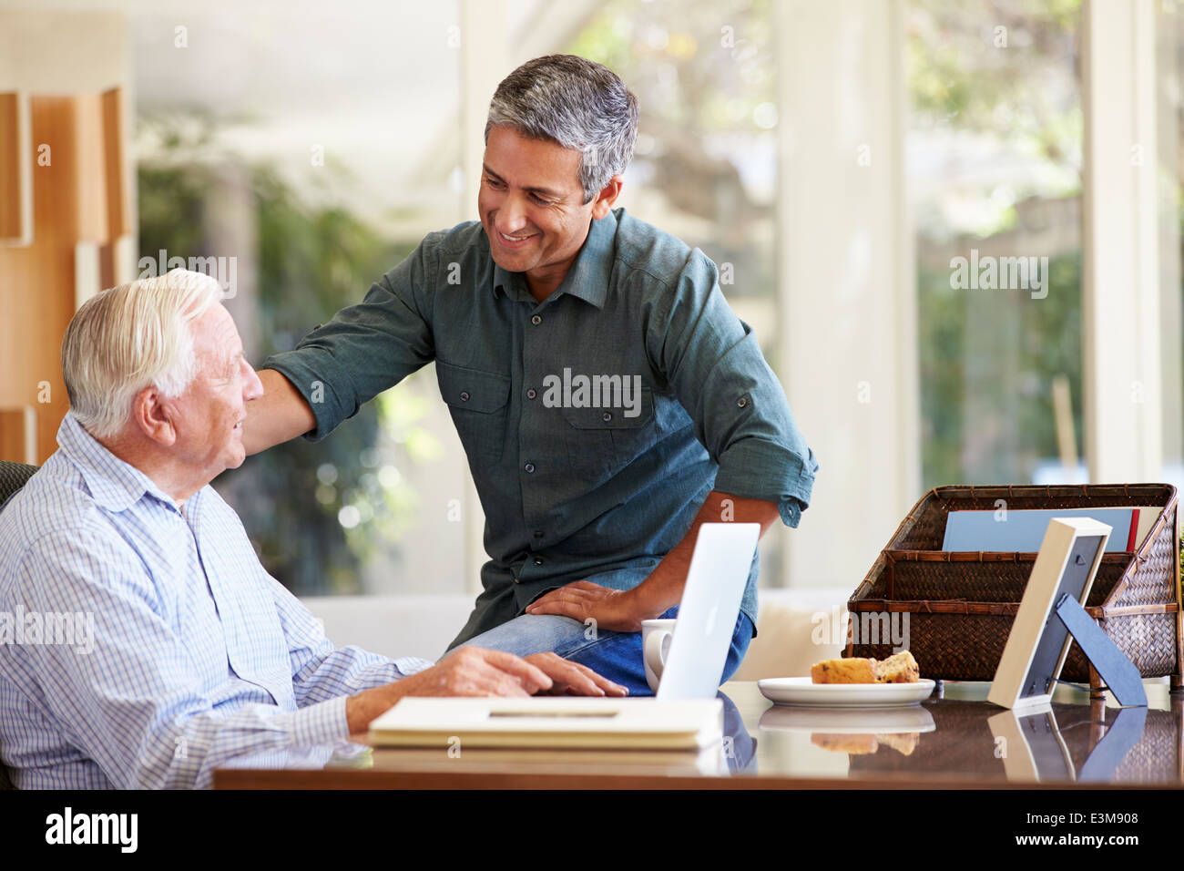 Adult Son Helping Father With Laptop Stock Photo