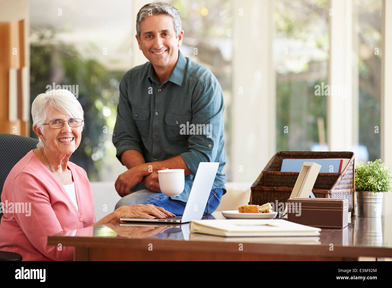 Adult Son Helping Mother With Laptop Stock Photo