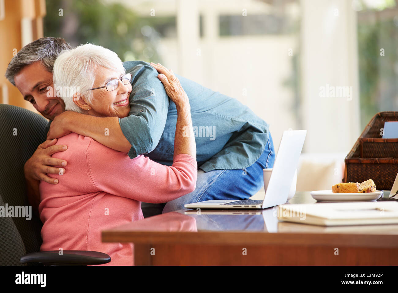 Senior Mother Being Comforted By Adult Son Stock Photo