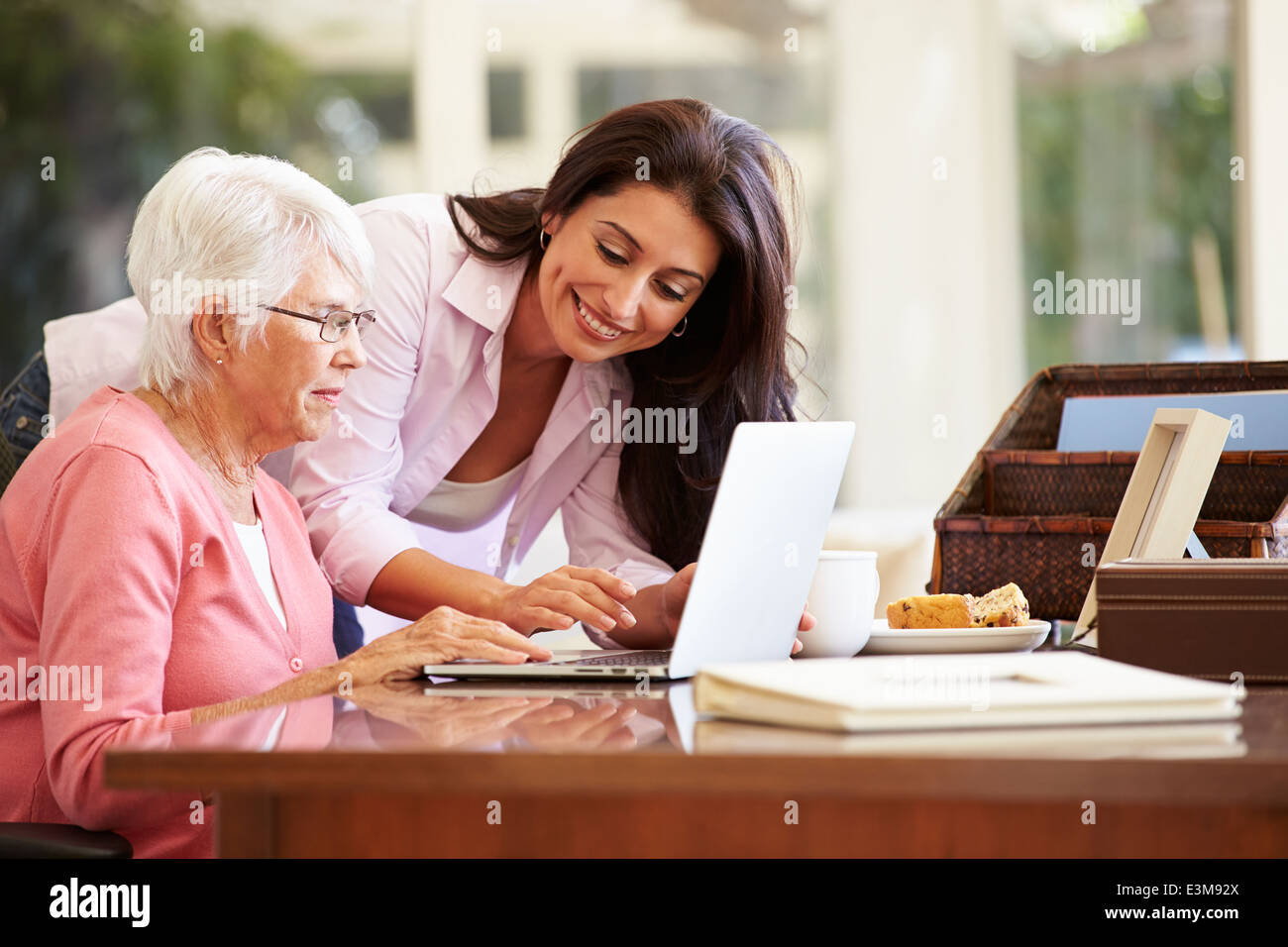 Woman helping daughter laptop hi-res stock photography and images - Alamy