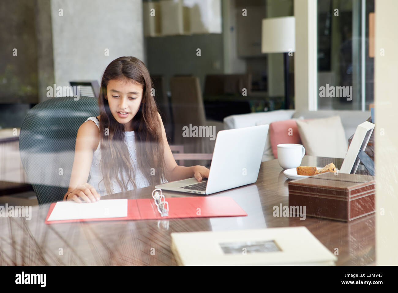 View Of Teenage Girl Using Laptop Through Window Stock Photo - Alamy