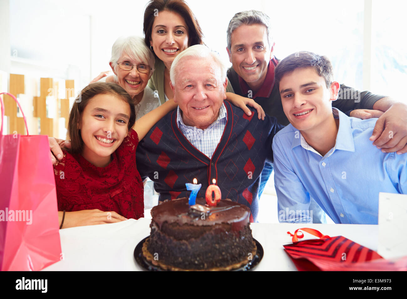 Family Celebrating 70th Birthday Together Stock Photo