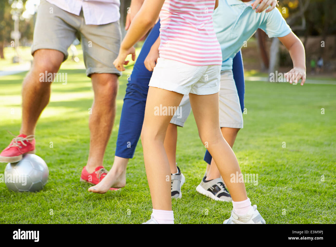 Close Up Of Family Playing Soccer In Park Together Stock Photo - Alamy