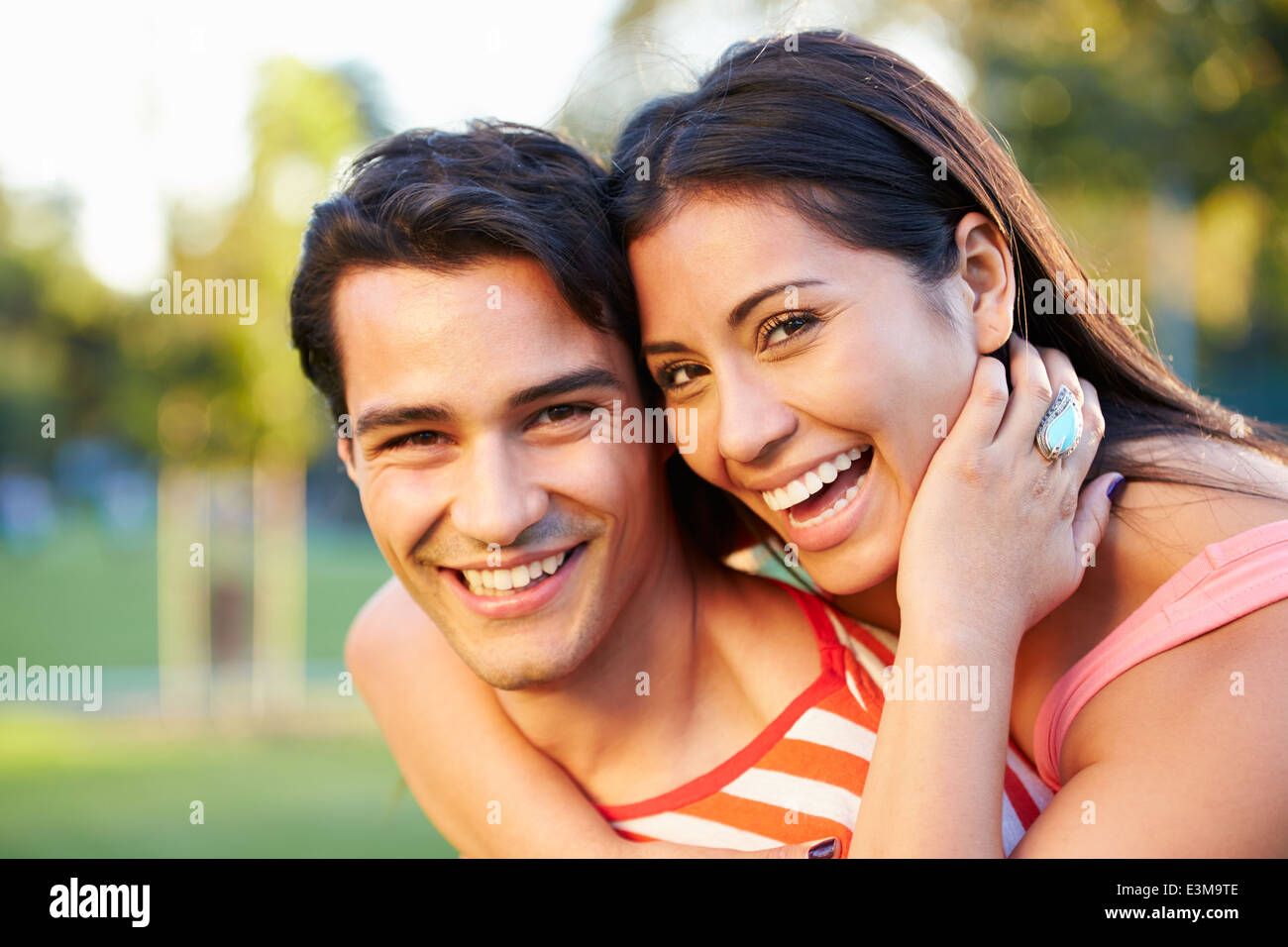 Outdoor Portrait Of Romantic Young Couple In Park Stock Photo