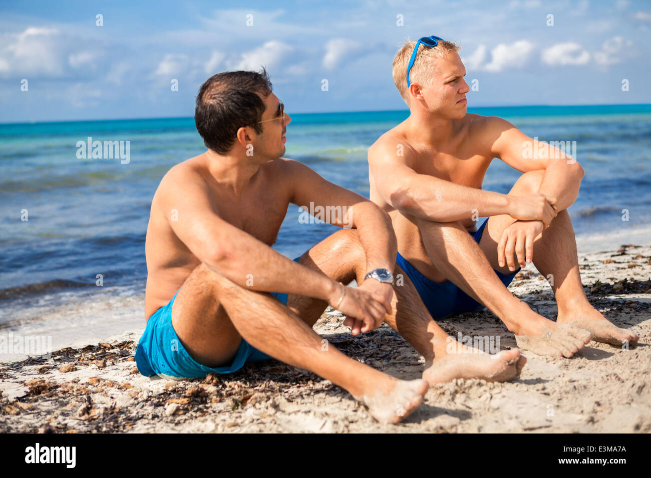 Two handsome young men chatting on a 