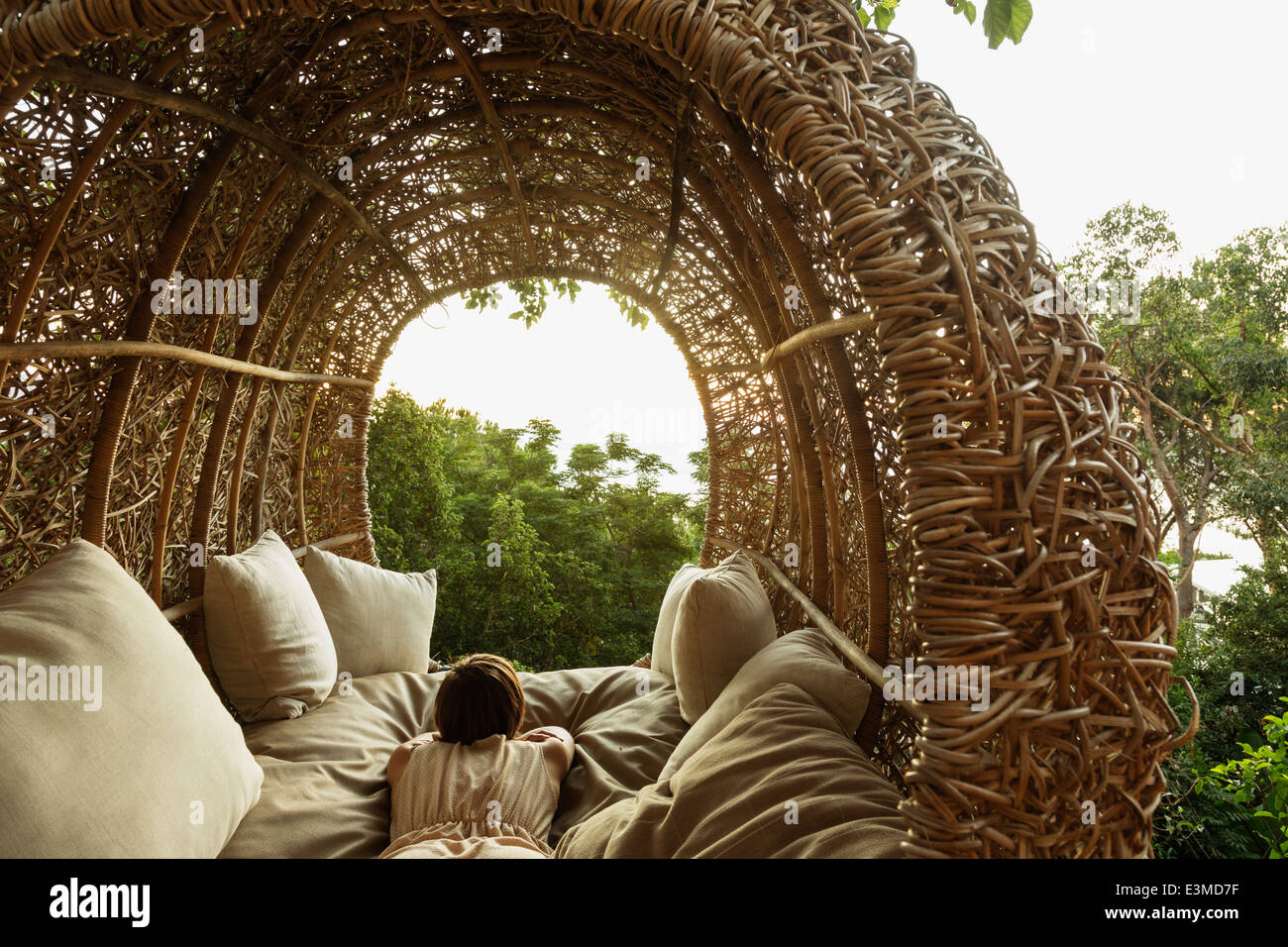 Woman laying in nest tree house Stock Photo