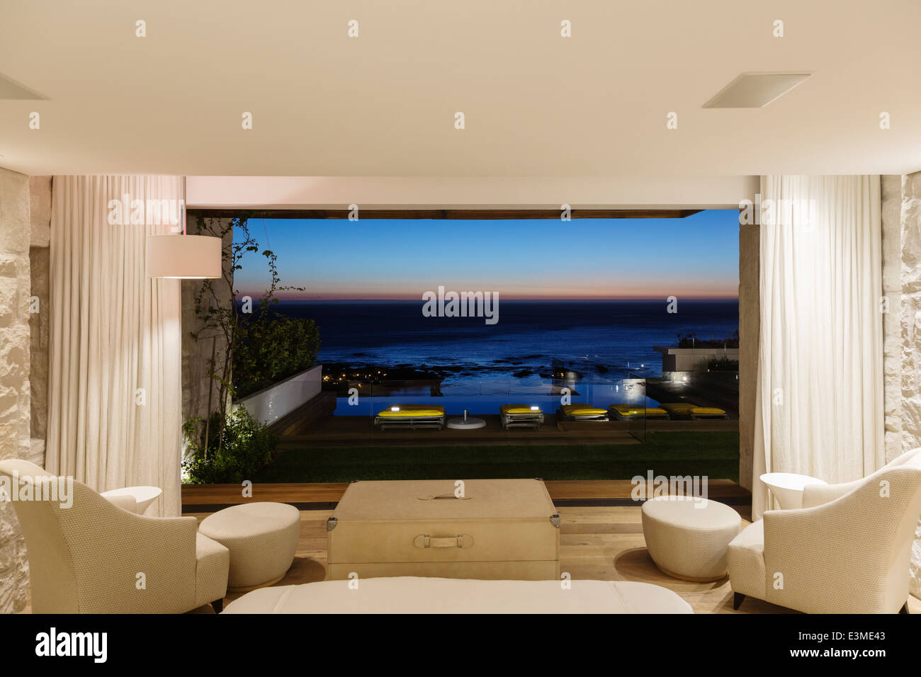 Modern bedroom overlooking ocean at night Stock Photo Alamy