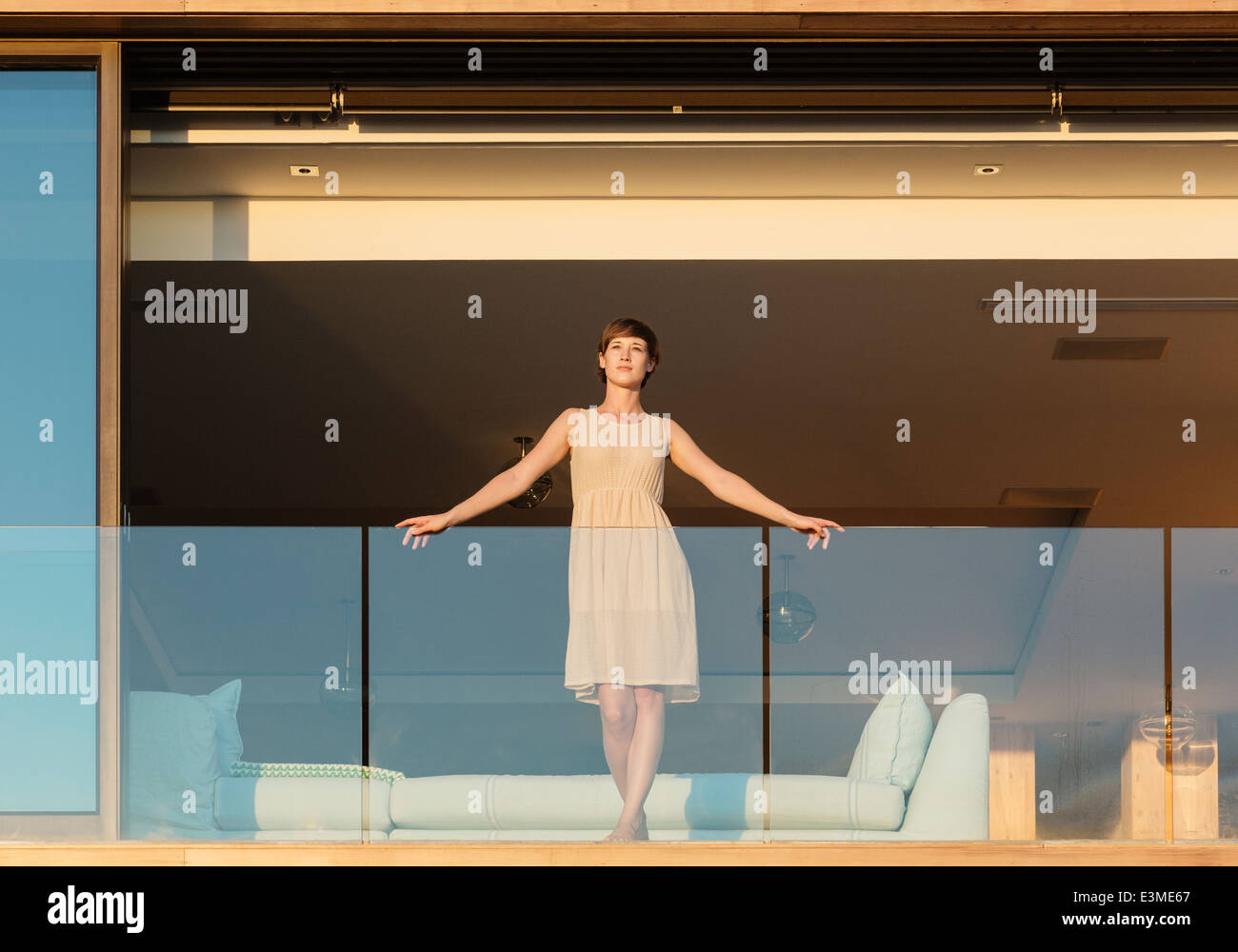 Woman standing on luxury balcony Stock Photo